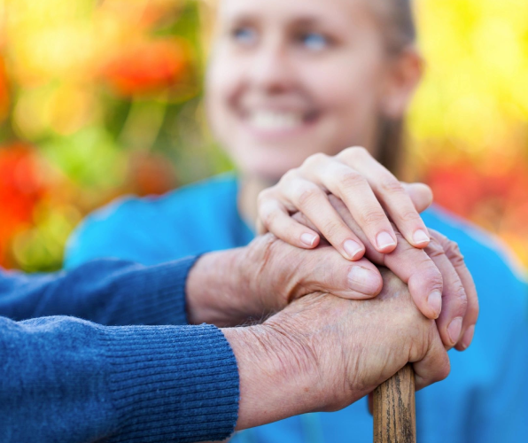 Two people holding hands on a stick