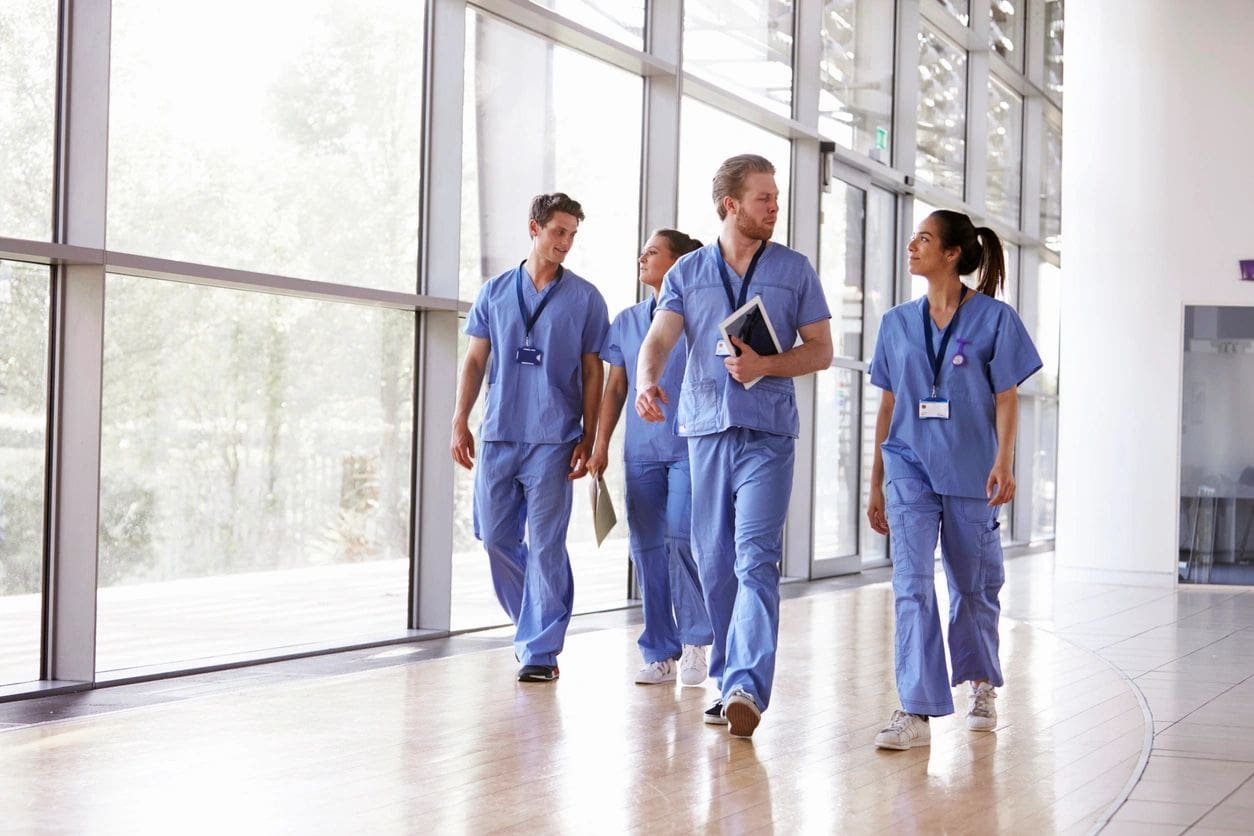 A group of doctors walking in the hallway.