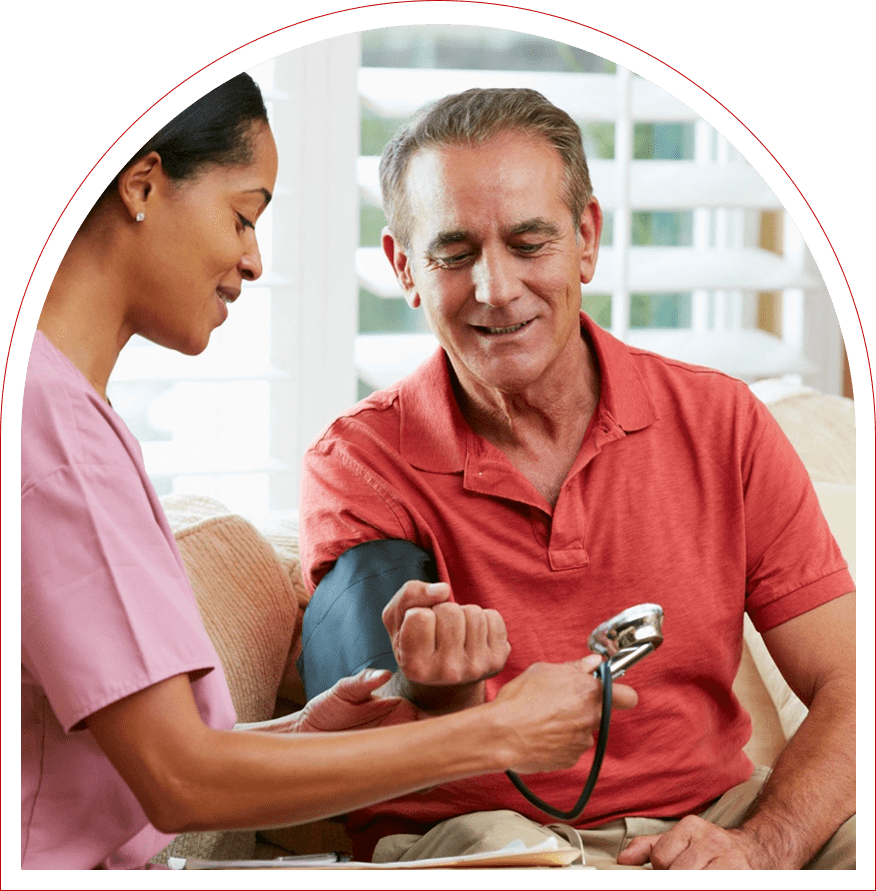 A nurse checking the blood pressure of an older man.